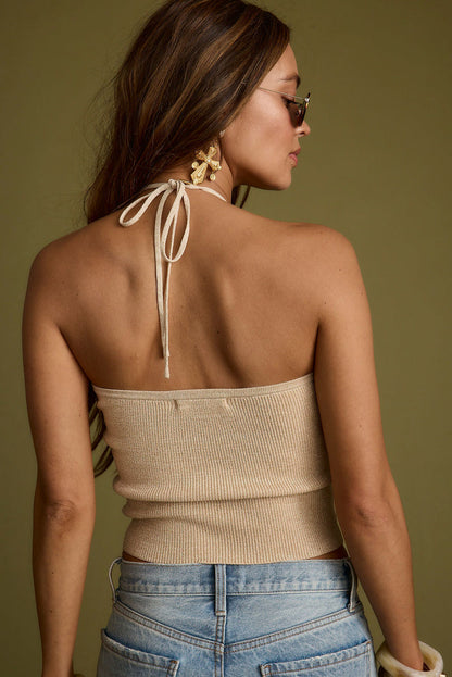 Back view of the gold halter top showing the silhouette and fit.