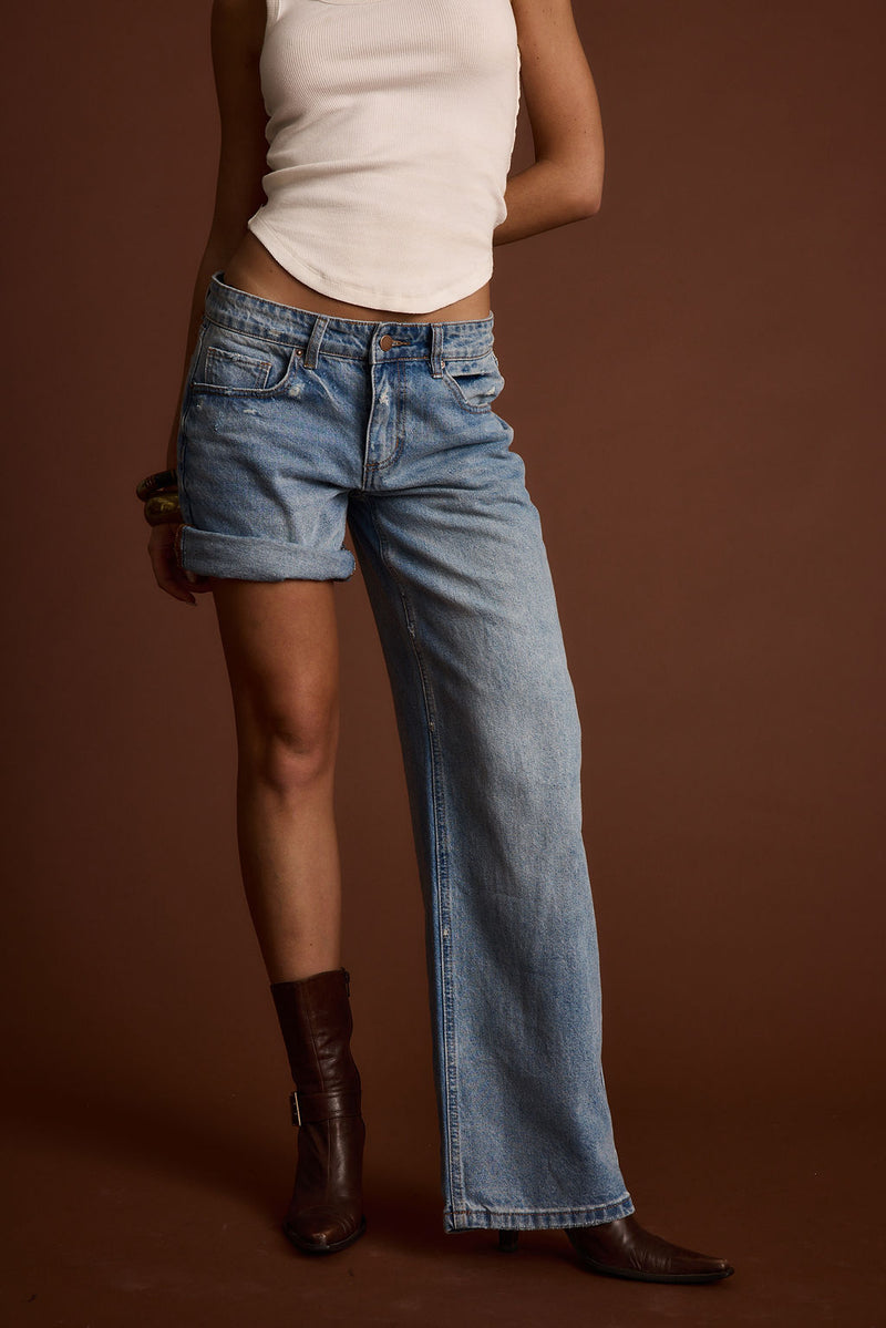 Lifestyle shot of the jeans styled for day-to-night versatility.